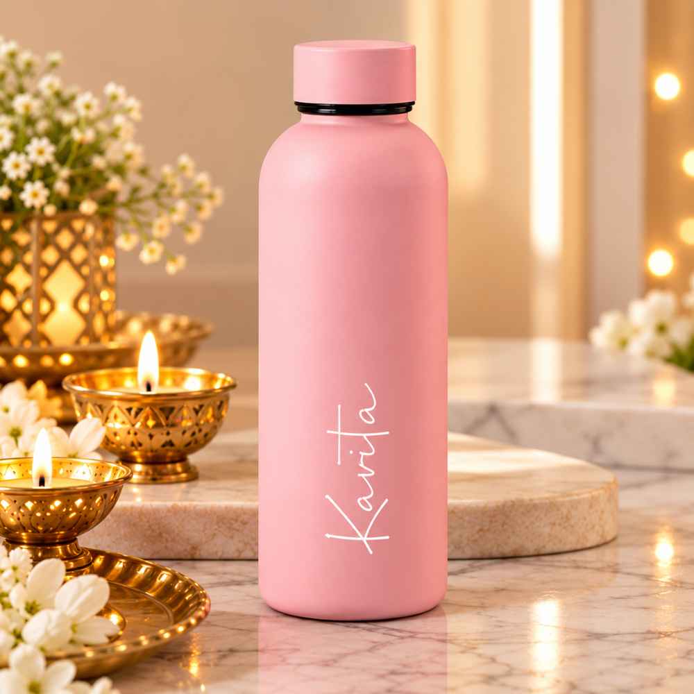 Customised pastel pink double wall stainless steel vacuum insulated water bottle with white name printing."
