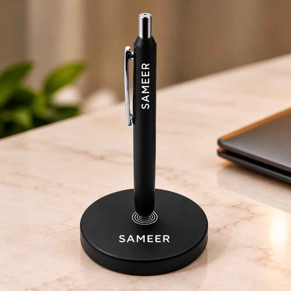 "Executive matte black standing ballpoint pen on magnetic desk base personalized with custom name."
