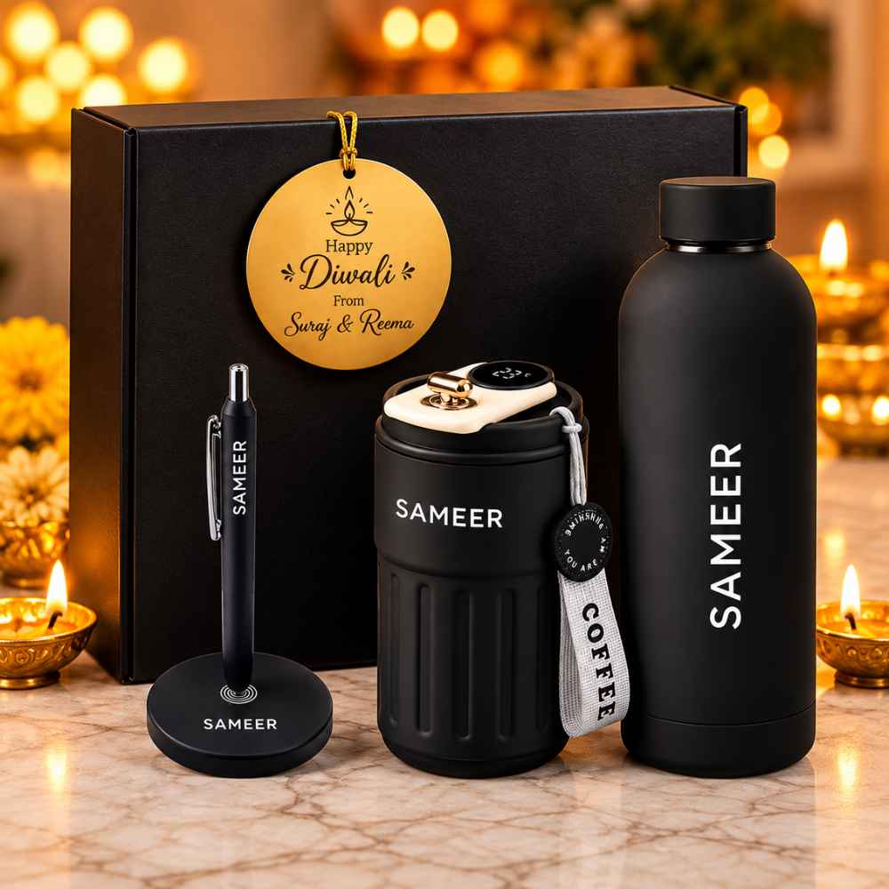  "Personalised matte black corporate Diwali gift hamper box including custom water bottle, smart coffee tumbler, magnetic pen stand, and golden Diwali tag."
