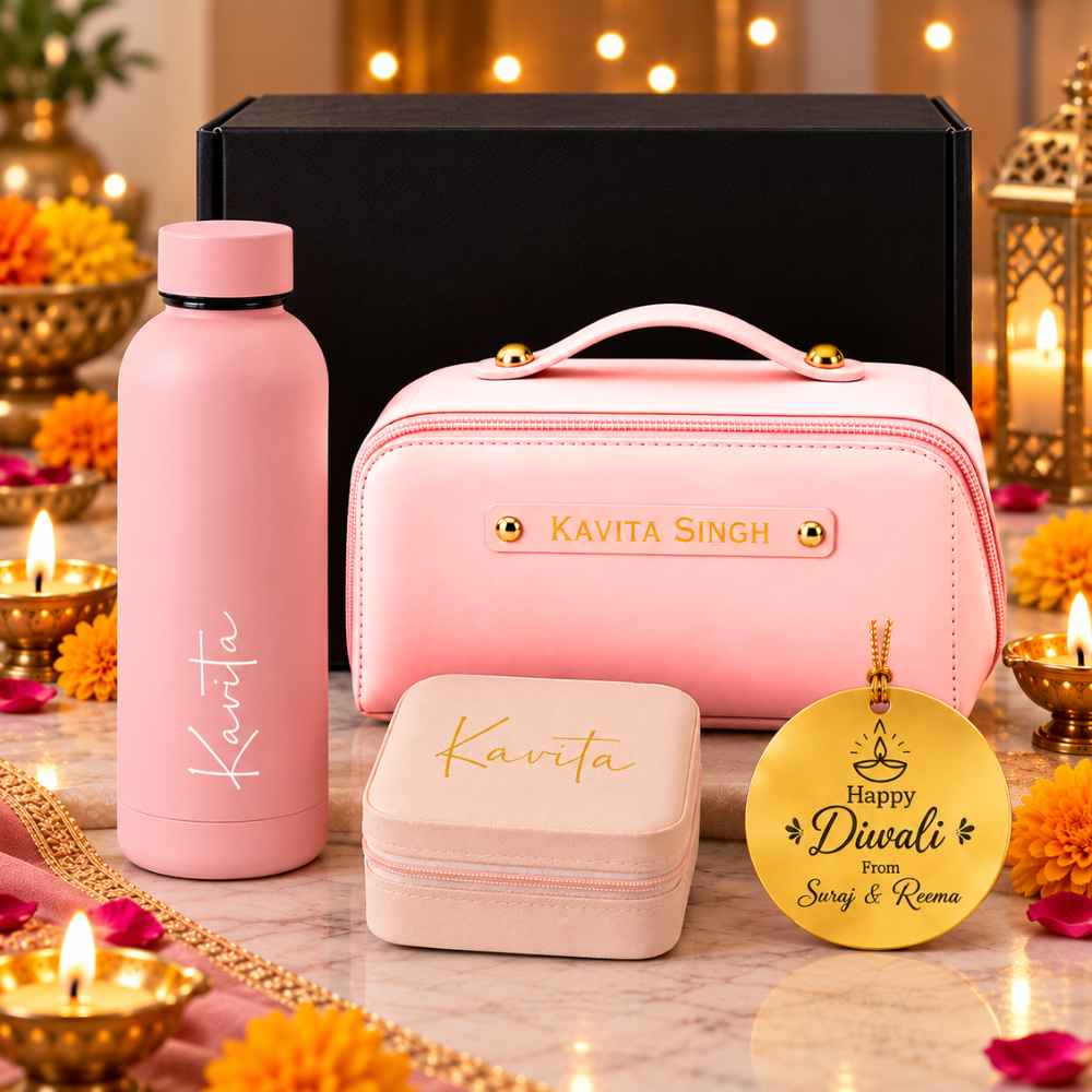 "Personalised corporate Diwali gift hamper set featuring custom bottle, pink travel pouch, square jewelry box, and golden tag."
